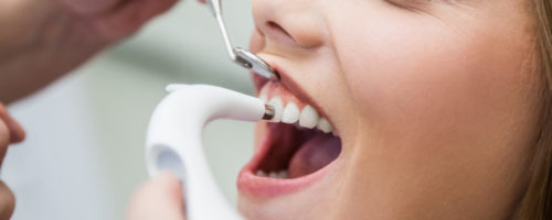 Female Patient Treated With Dental Equipment
